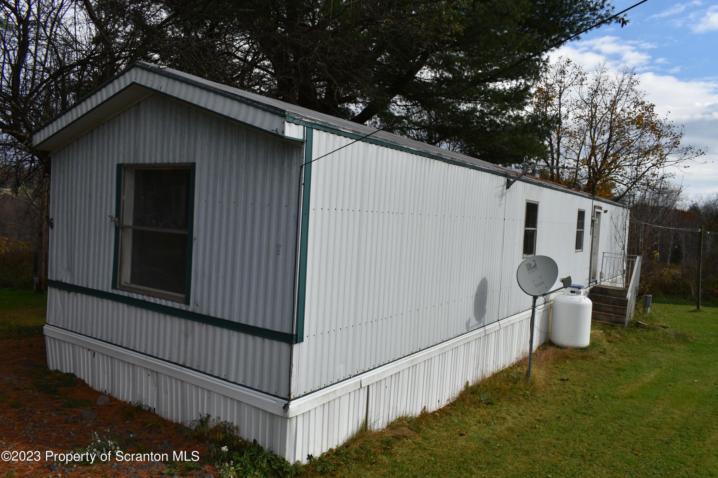 940 Nowlan Road, Unit 6 Port Crane, NY 13833 - Photo 5 of 11 a view of a wooden house with a yard and seating space