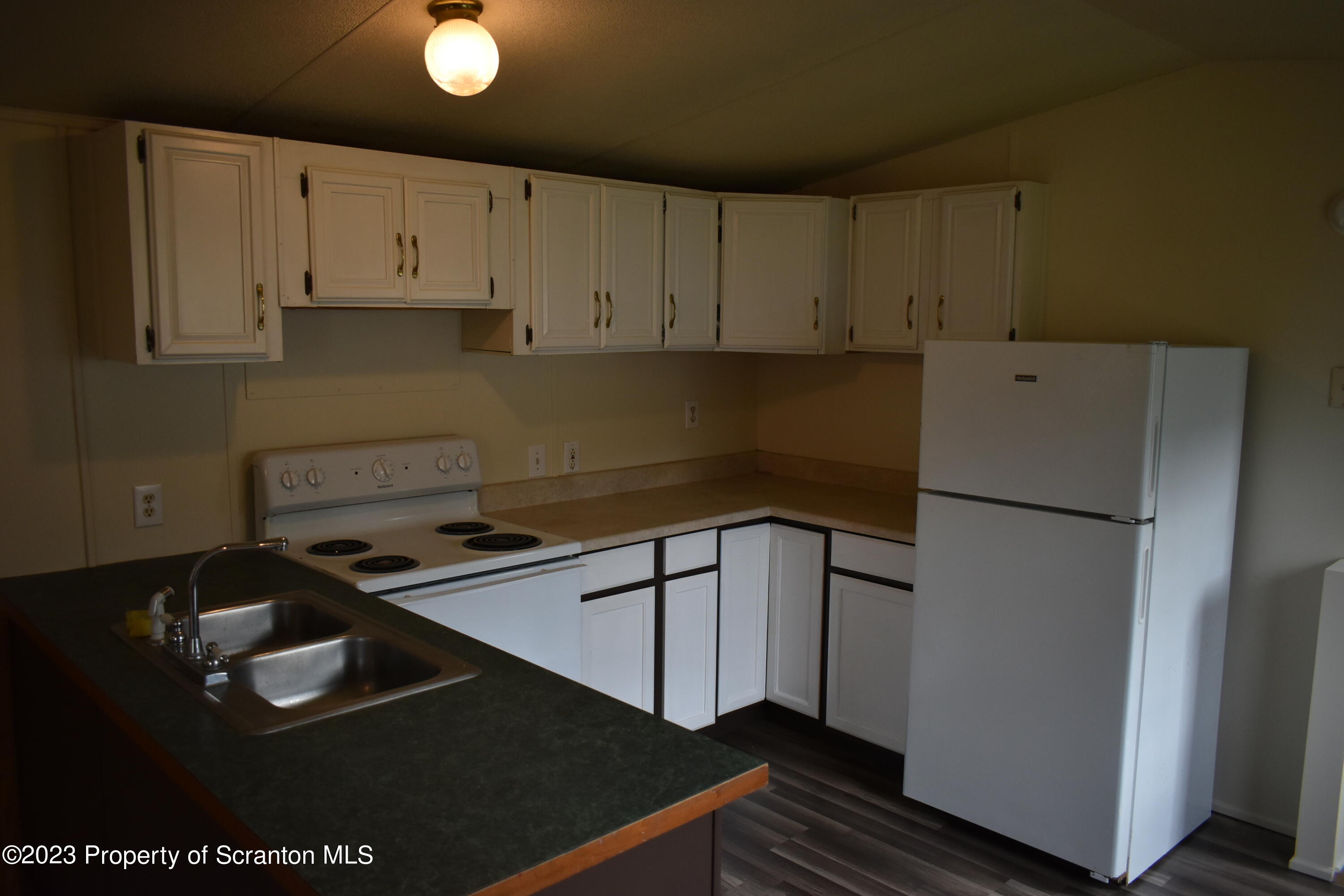 940 Nowlan Road, Unit 6 Port Crane, NY 13833 - Photo 7 of 11 a kitchen with a refrigerator and a stove