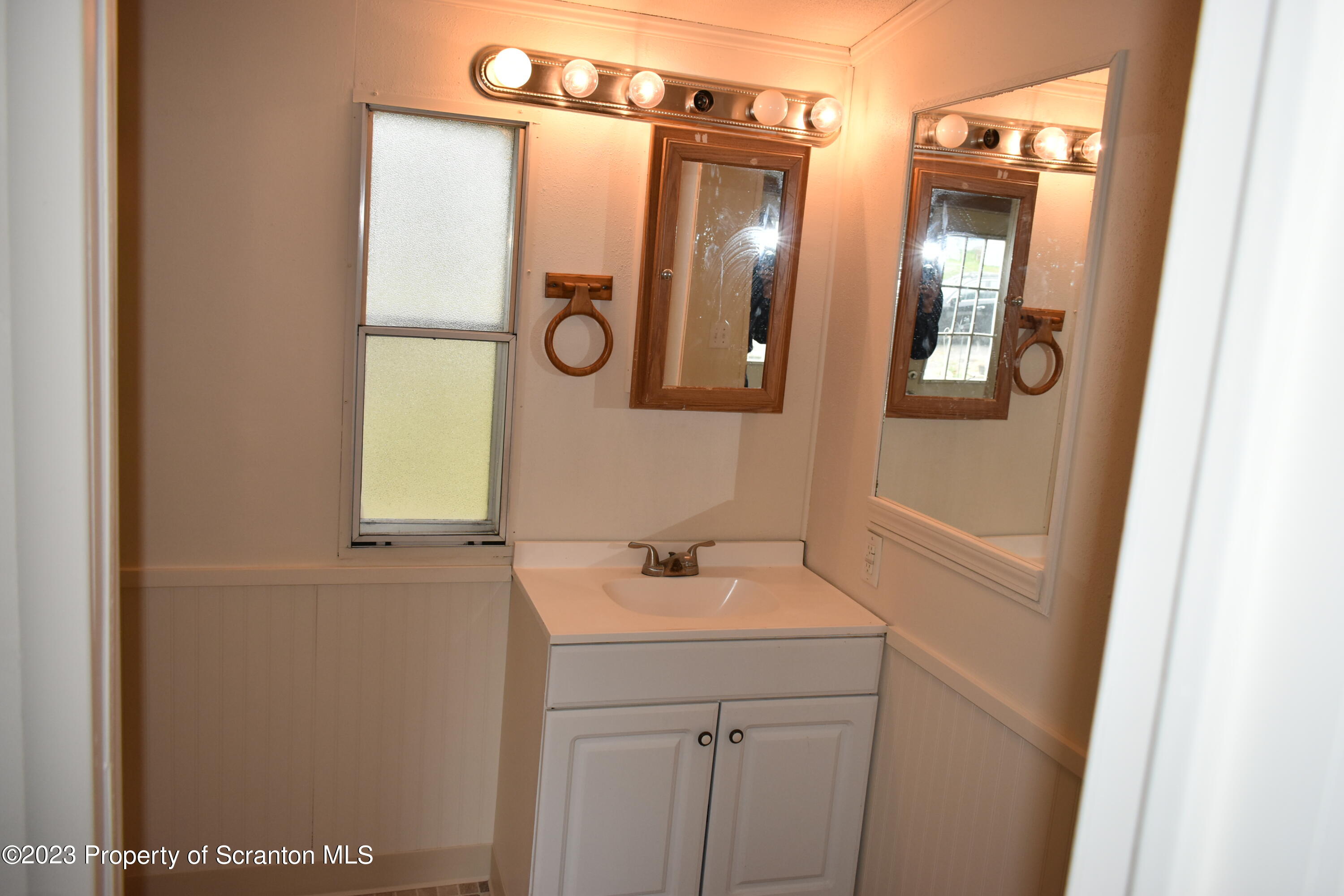 940 Nowlan Road, Unit 6 Port Crane, NY 13833 - Photo 9 of 11 a bathroom with a sink and mirror