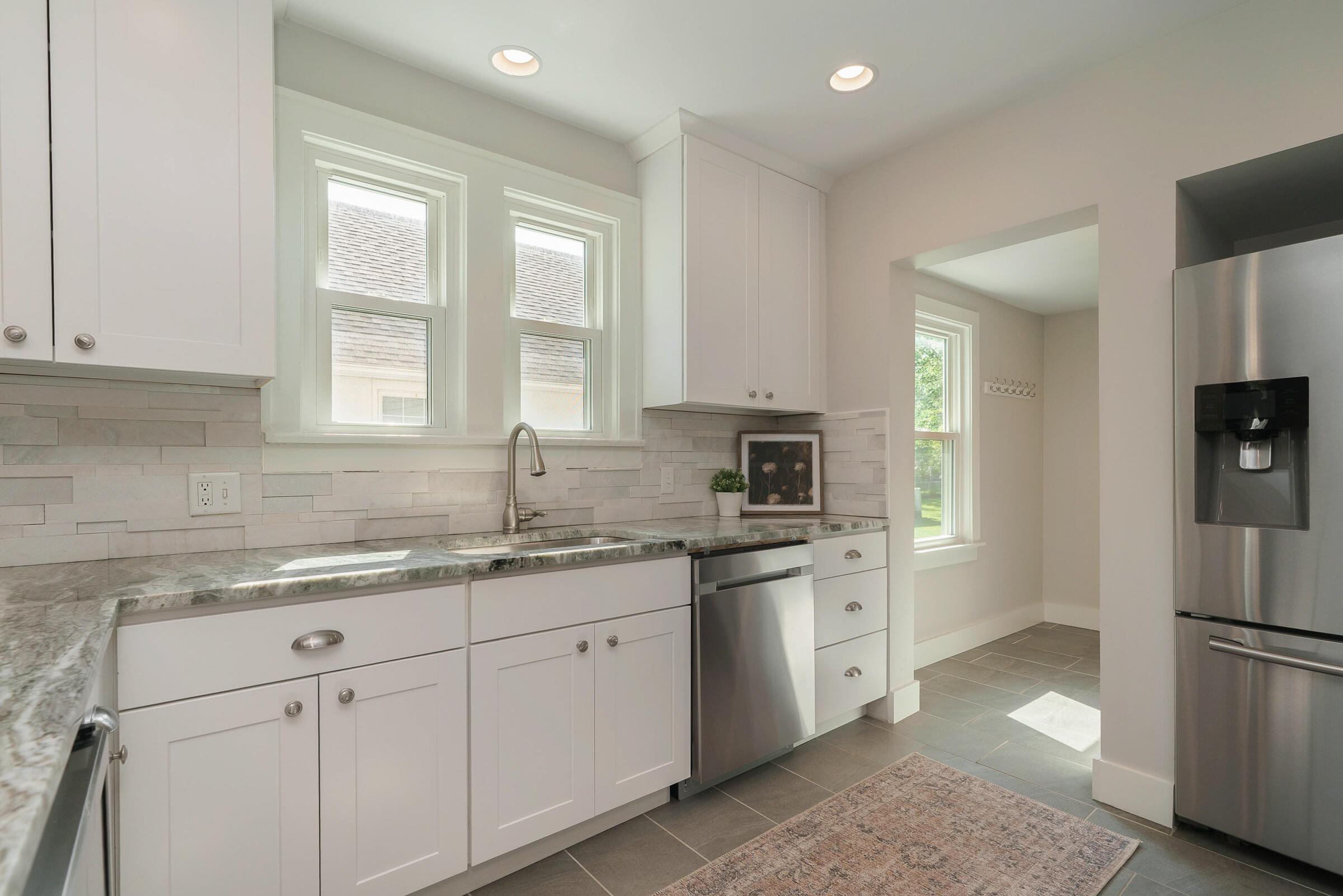 163 Garden Road Columbus, OH 43214 - Photo 15 of 46 This outstanding kitchen boasts updated stainless steel appliances and custom tile backsplash, complimenting the granite counters.