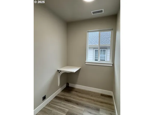 a view of a house with backyard and wooden fence