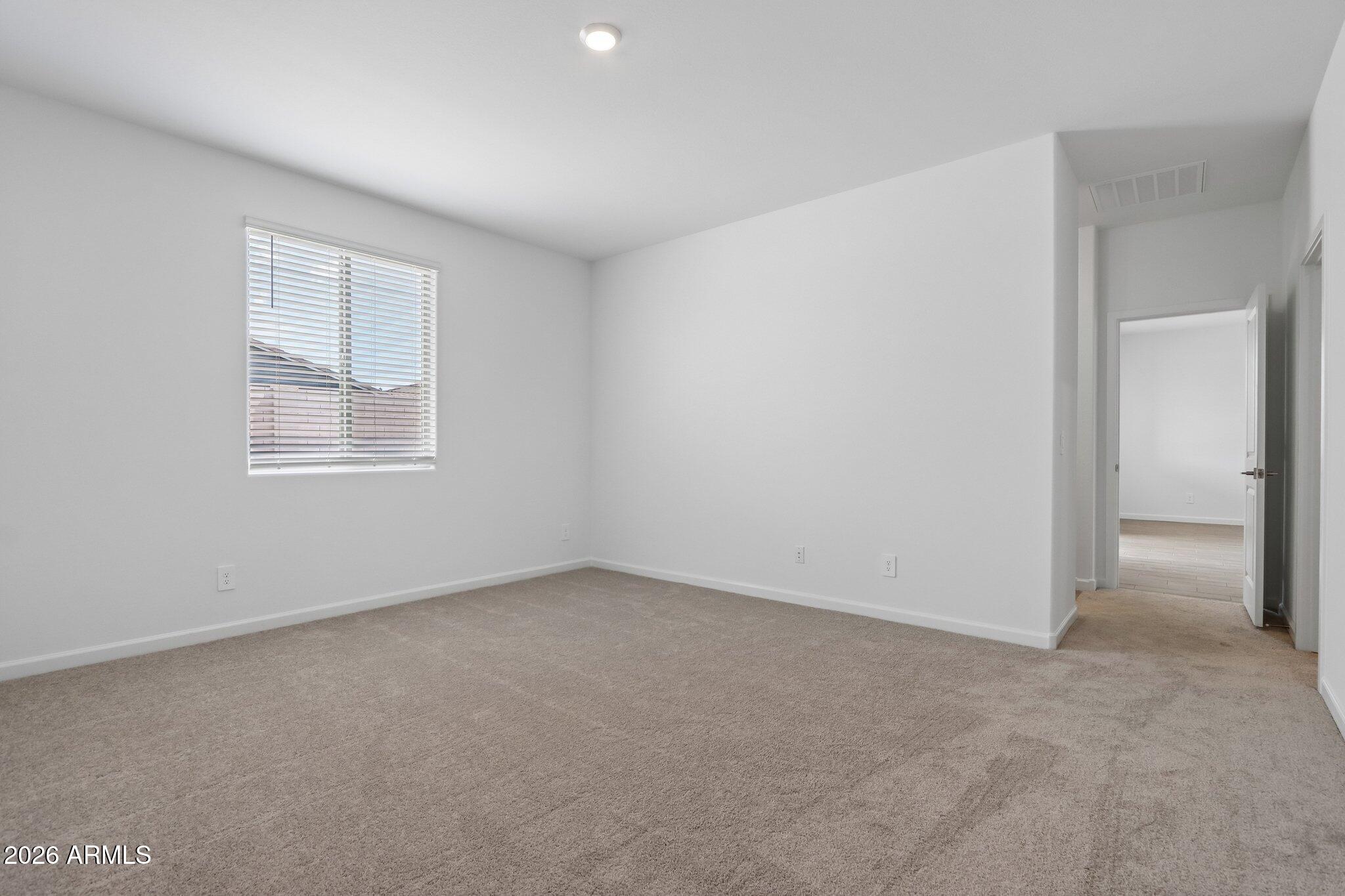 9544 West Gaby Road Tolleson, AZ 85353 - Photo 19 of 43 an empty room with a window