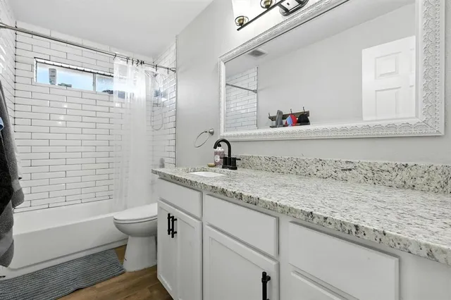 a bedroom with a bed and a computer on a desk