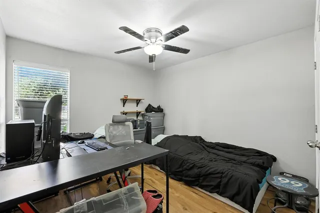 a view of a patio with table and chairs under an umbrella