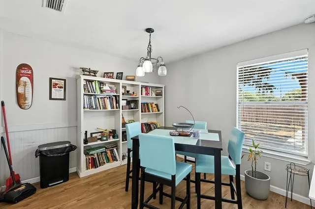 a kitchen with stainless steel appliances granite countertop a stove a sink dishwasher a refrigerator and a microwave oven with wooden floor