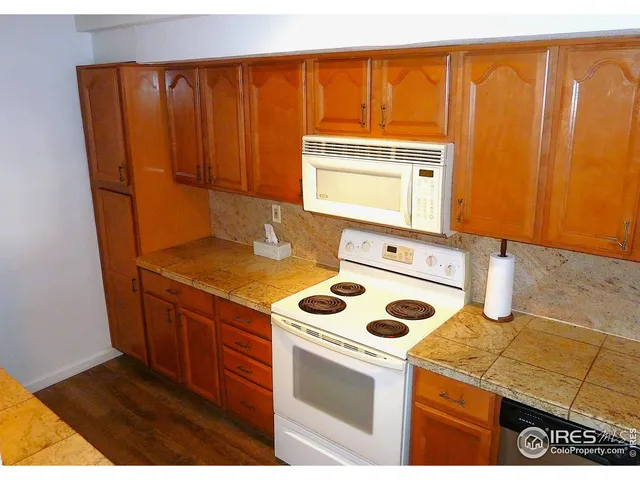 a kitchen with a sink a stove and cabinets