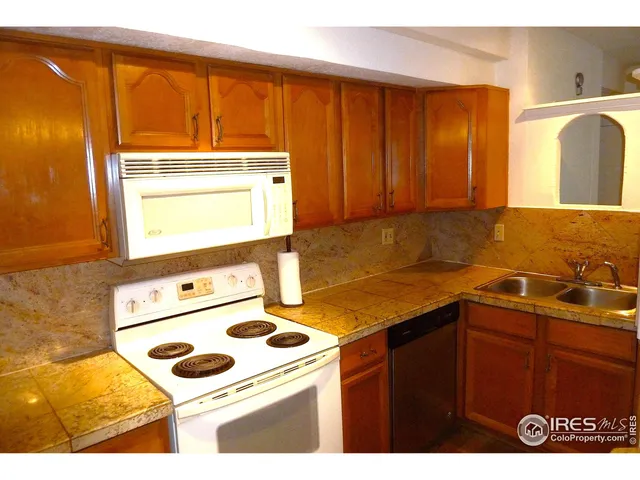 a kitchen that has a sink and a stove