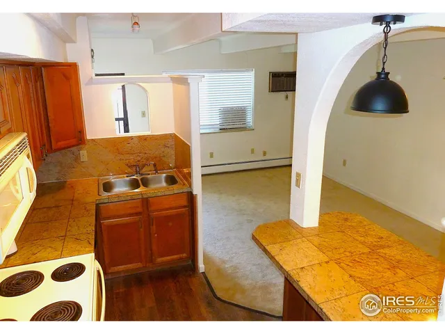 a kitchen with stainless steel appliances granite countertop a sink a stove and a refrigerator