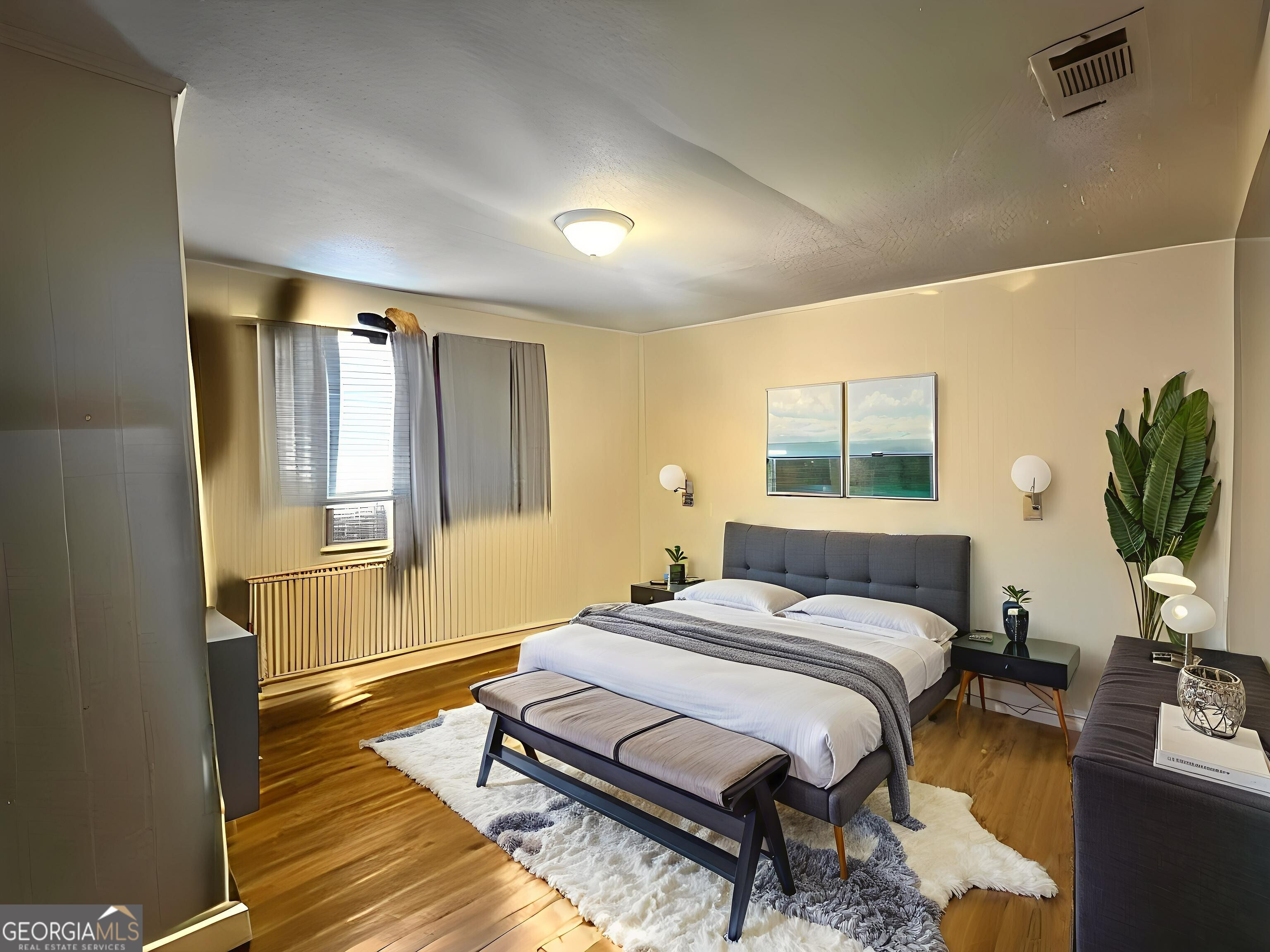 103 Floyd Street Statesboro, GA 30458 - Photo 16 of 22 a bedroom with a bed flat screen tv and windows