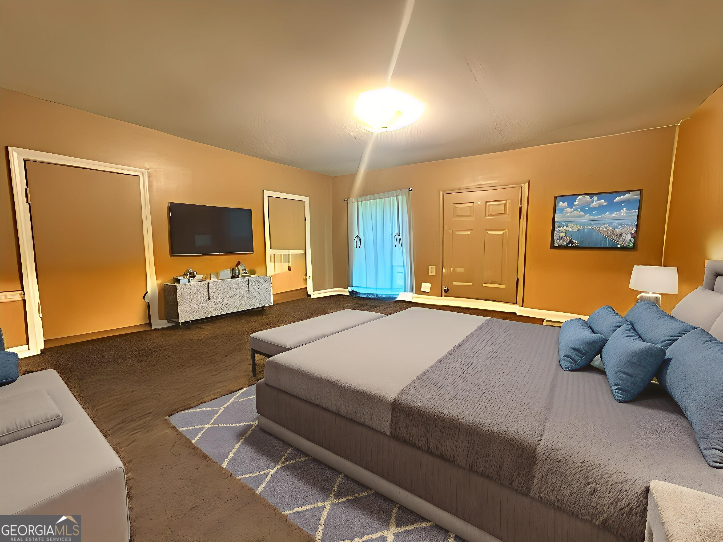 103 Floyd Street Statesboro, GA 30458 - Photo 5 of 22 a spacious bedroom with a bed and a flat screen television