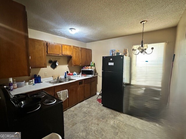 103 Floyd Street Statesboro, GA 30458 - Photo 8 of 22 a kitchen with a refrigerator and a sink
