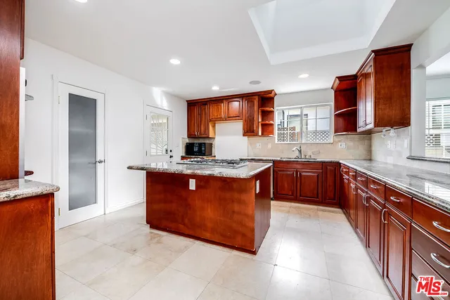 a kitchen with stainless steel appliances granite countertop a stove a sink dishwasher and a refrigerator