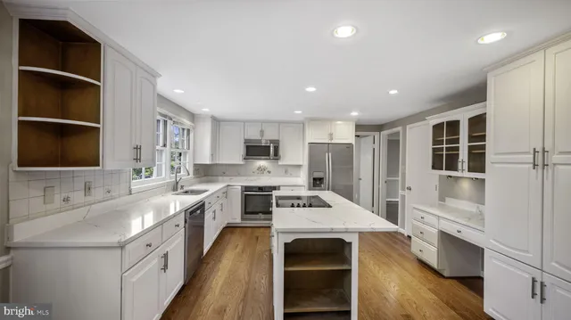 a kitchen with a stove a sink and a refrigerator