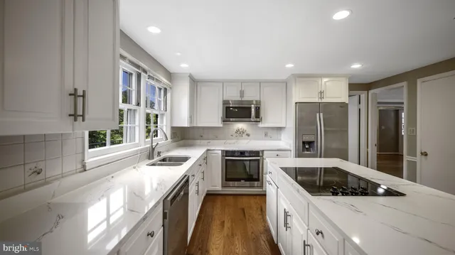 a kitchen with a refrigerator and a stove top oven