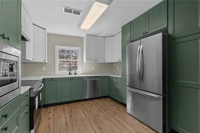 a kitchen with a refrigerator and a sink