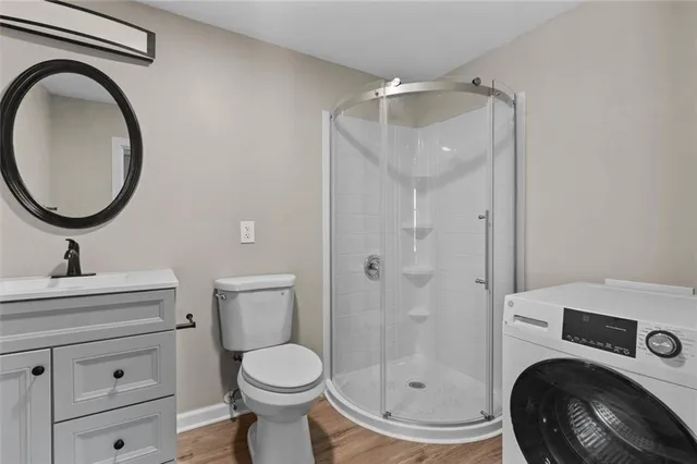 a bathroom with a sink a toilet and a mirror