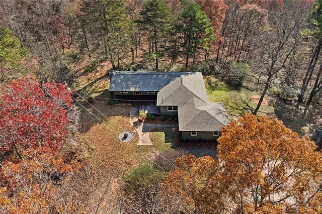 a view of a house with a yard and sitting area