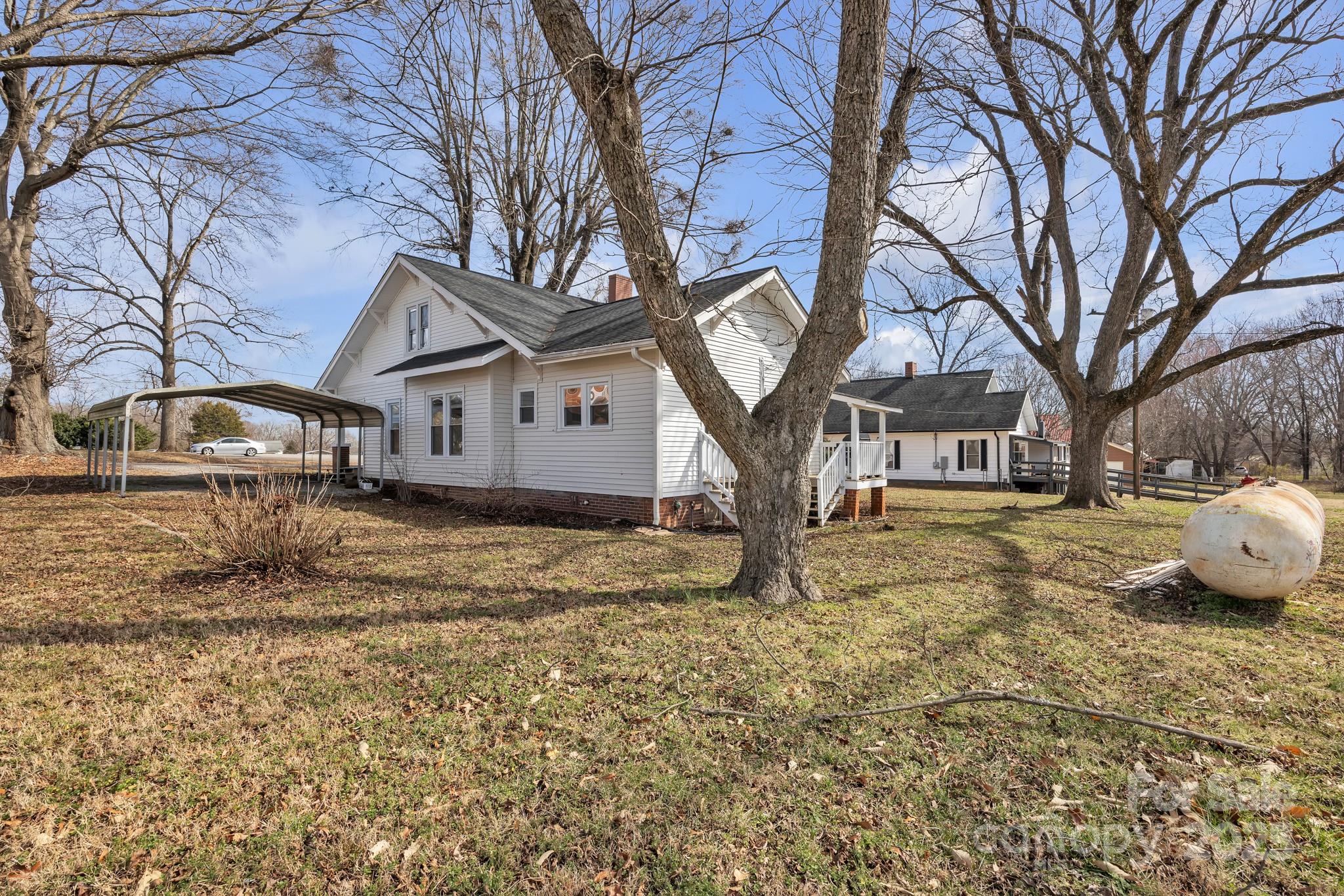 34 Lee Road Stony Point, NC 28678 - Photo 16 of 22 a house with trees in front of it