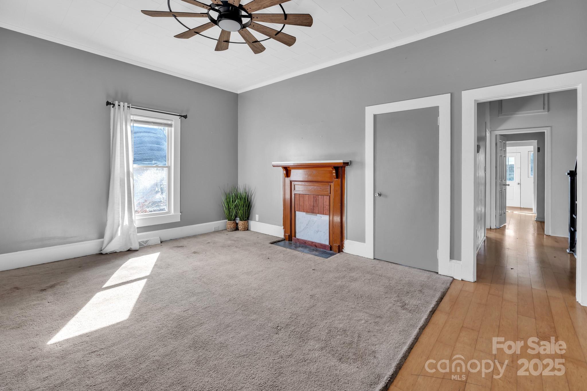 34 Lee Road Stony Point, NC 28678 - Photo 6 of 22 a view of a livingroom with a chandelier fan and windows