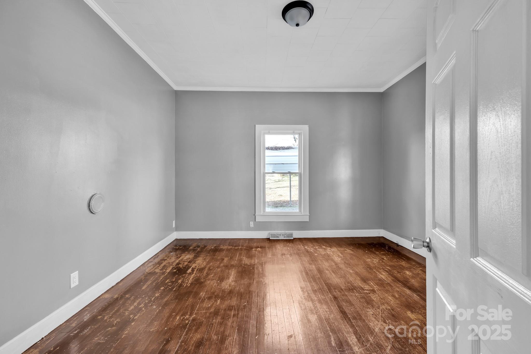 34 Lee Road Stony Point, NC 28678 - Photo 8 of 22 a view of an empty room with wooden floor and a window