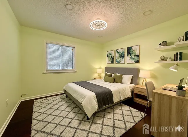 a bedroom with a bed and wall painting on the wall