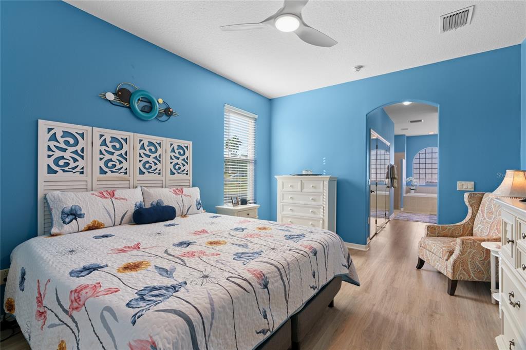 15657 Southwest 11th Terrace Road Ocala, FL 34473 - Photo 17 of 42 a bedroom with a bed and wooden floor