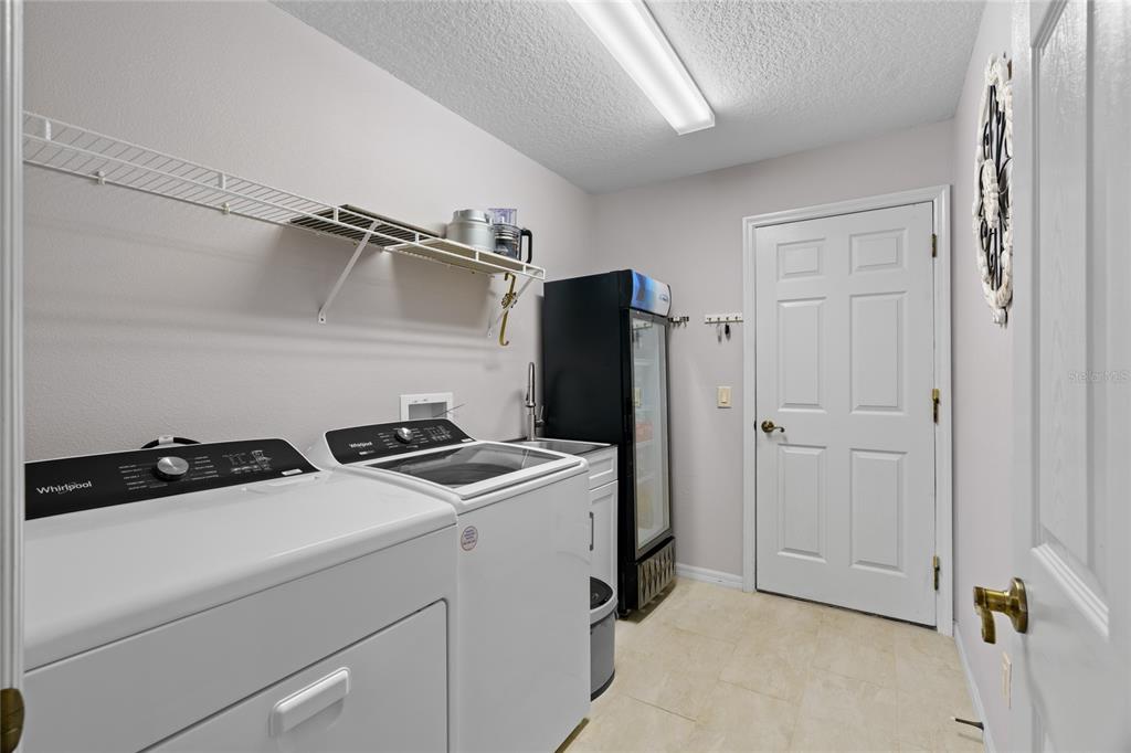 15657 Southwest 11th Terrace Road Ocala, FL 34473 - Photo 28 of 42 a utility room with dryer and washer