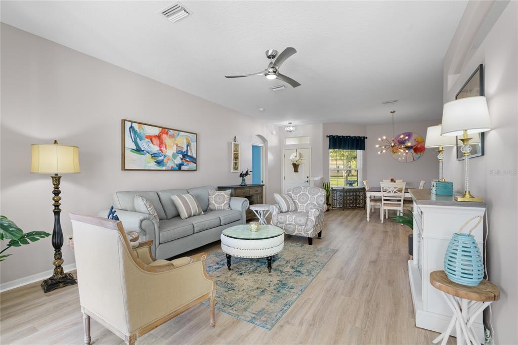 15657 Southwest 11th Terrace Road Ocala, FL 34473 - Photo 8 of 42 a living room with furniture and a wooden floor