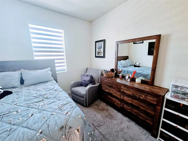 a bedroom with bed and a window