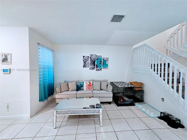 a living room with furniture and a rug