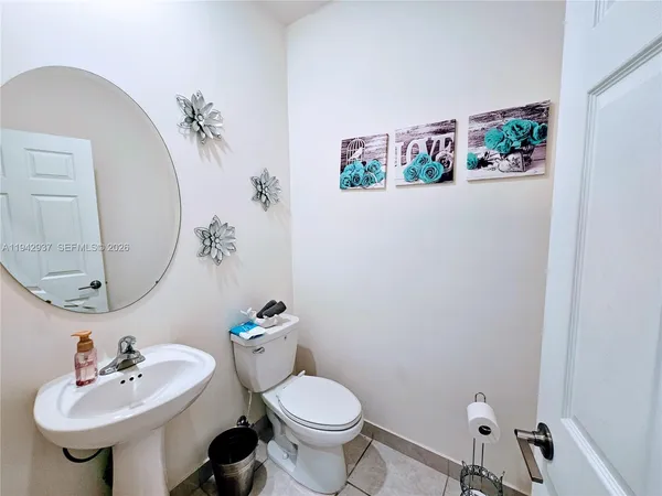 a bathroom with a sink mirror and toilet