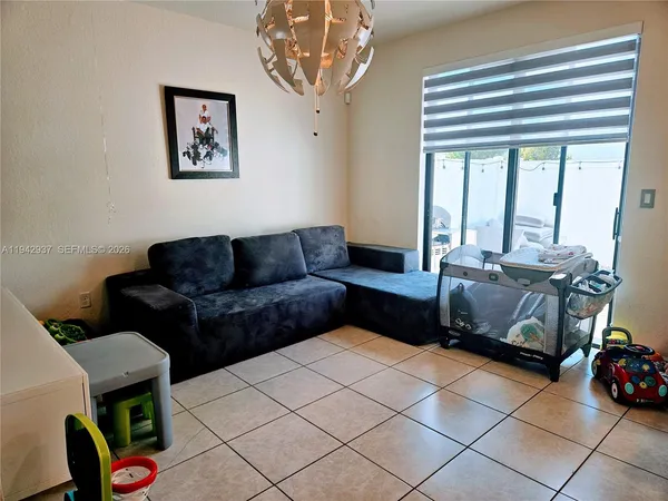 a living room with furniture and a large window