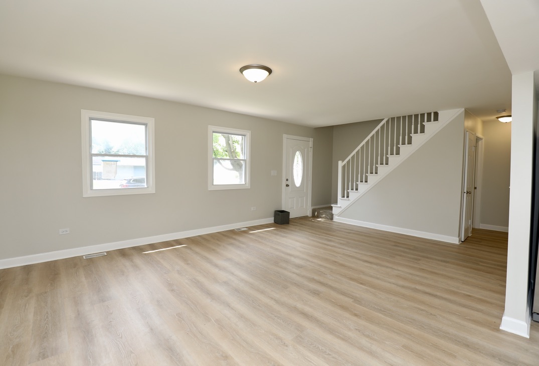 544 Spruce Road Bolingbrook, IL 60440 - Photo 4 of 13 a view of an empty room with wooden floor and a window