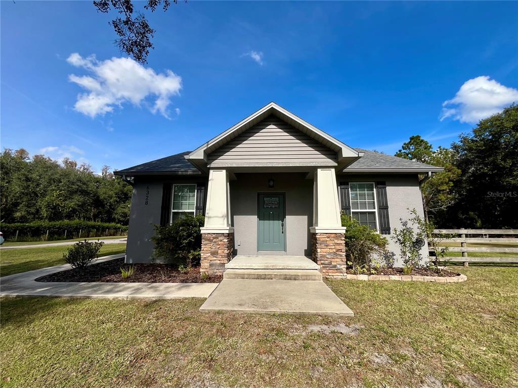 6328 Barton Road Plant City, FL 33565 - Photo 1 of 28 a front view of a house with garden