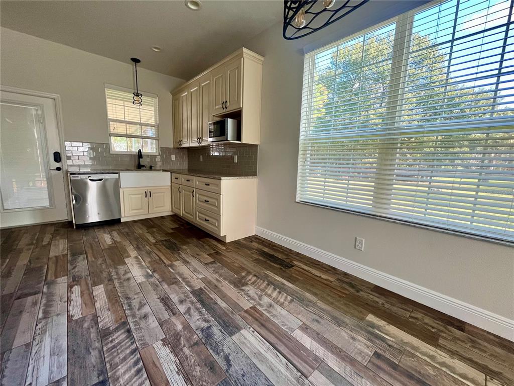 6328 Barton Road Plant City, FL 33565 - Photo 13 of 28 a large kitchen with granite countertop a large window a sink and stainless steel appliances