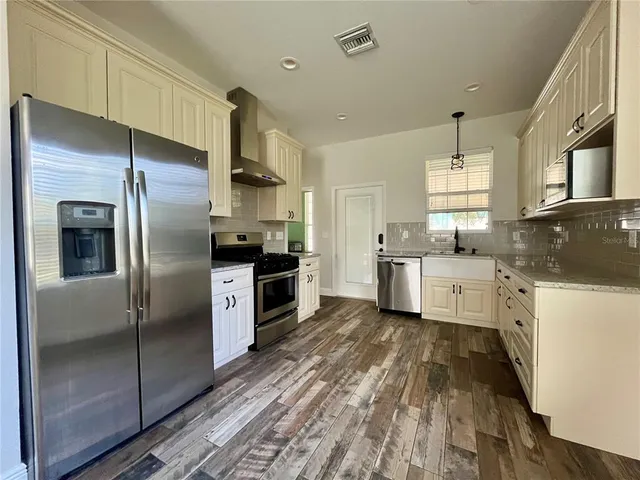 a kitchen with a refrigerator and a sink