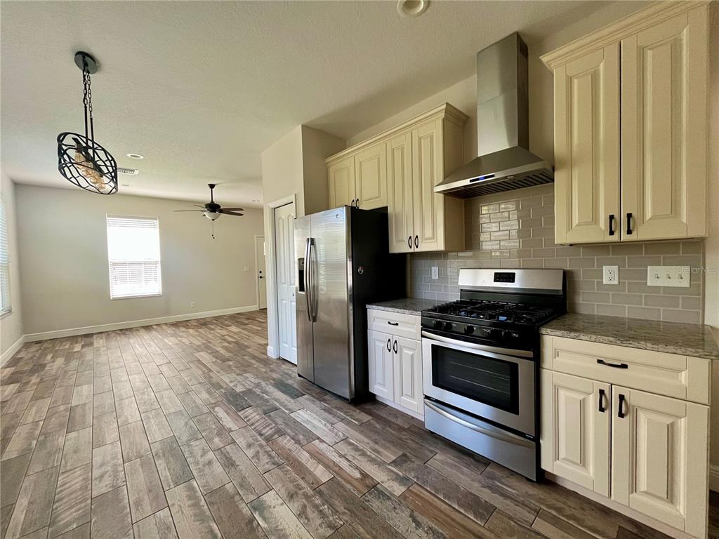 6328 Barton Road Plant City, FL 33565 - Photo 15 of 28 a kitchen with granite countertop a stove a sink and a refrigerator