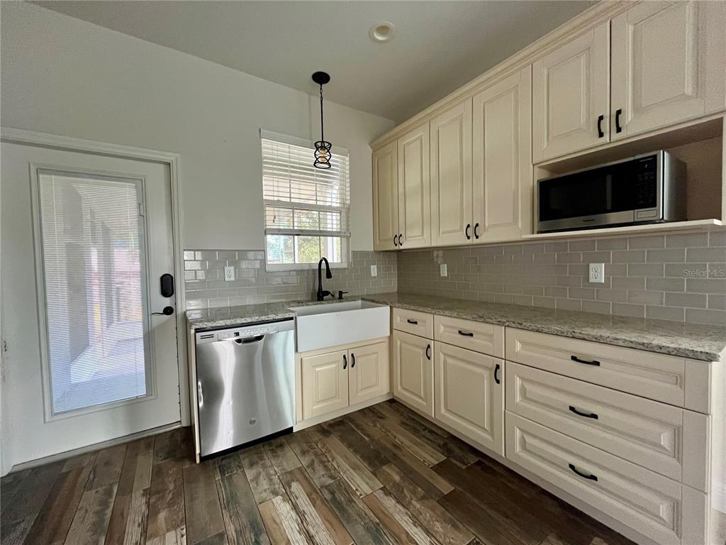 6328 Barton Road Plant City, FL 33565 - Photo 16 of 28 a kitchen with stainless steel appliances granite countertop a sink a stove and a granite counter tops
