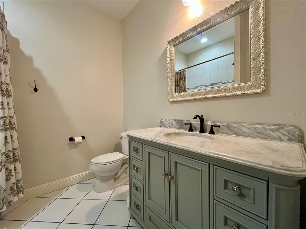 6328 Barton Road Plant City, FL 33565 - Photo 21 of 28 a bathroom with a granite countertop sink and a mirror