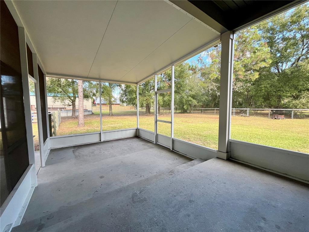 6328 Barton Road Plant City, FL 33565 - Photo 27 of 28 a view of an empty room with wooden floor and a floor to ceiling window