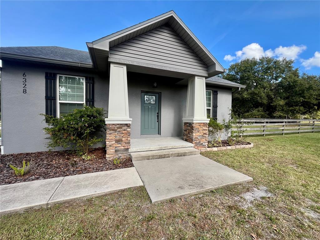6328 Barton Road Plant City, FL 33565 - Photo 7 of 28 a front view of a house with garden