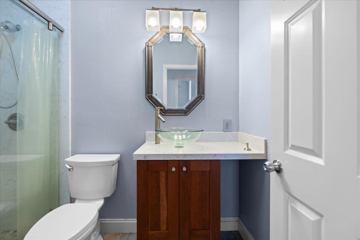 478 Churchill Way Salinas, CA 93906 - Photo 21 of 31 a bathroom with a toilet a sink and mirror