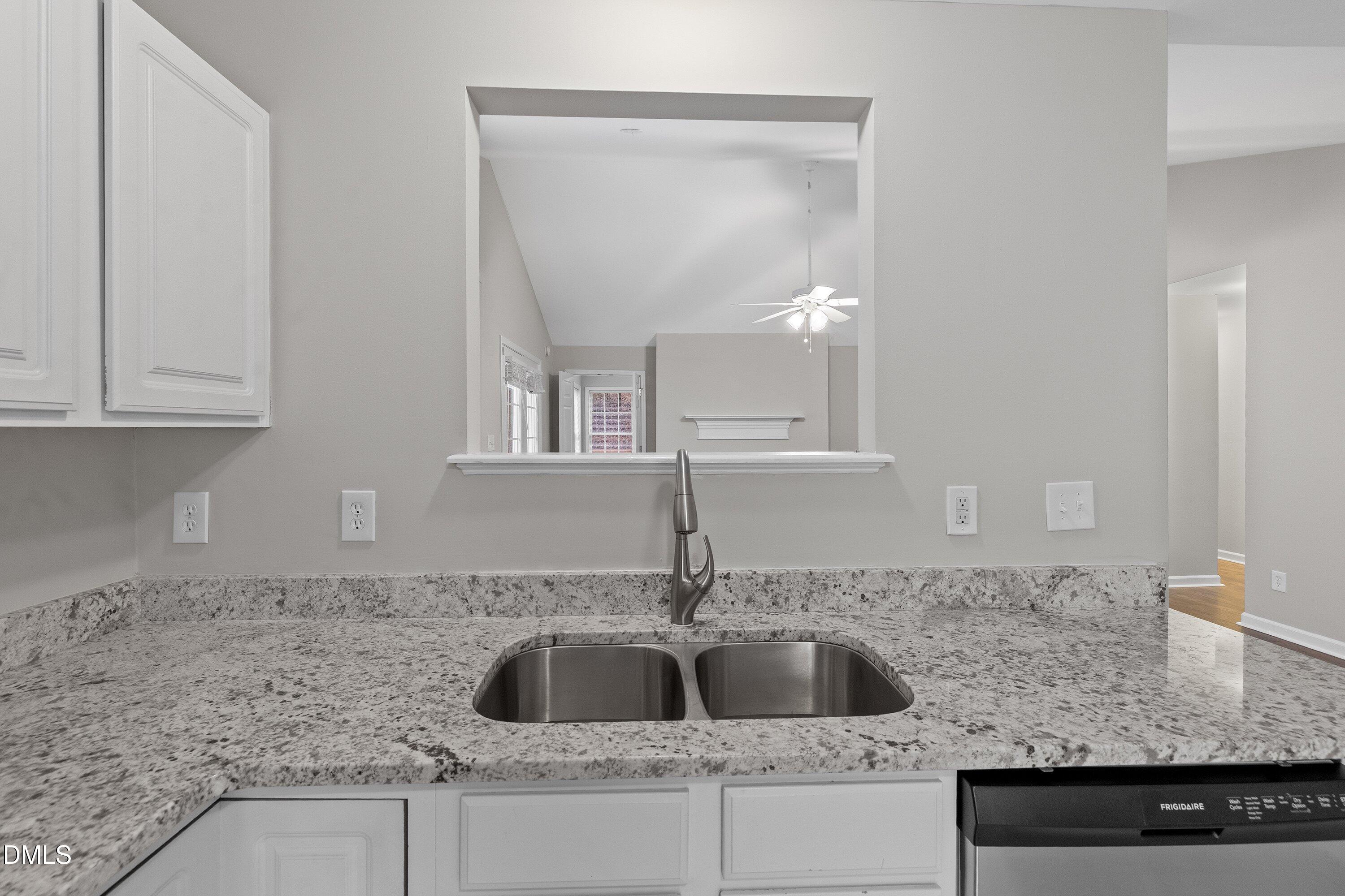 140 Melksham Road Wake Forest, NC 27587 - Photo 16 of 34 a kitchen with granite countertop a sink and cabinets