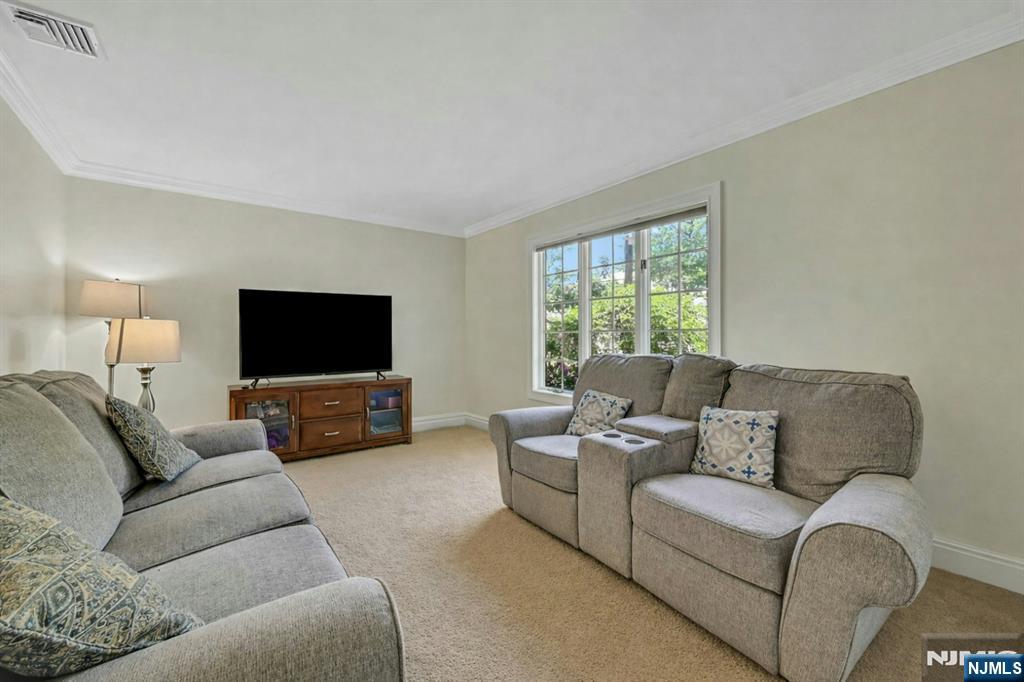 44 West Midland Avenue Paramus, NJ 07652 - Photo 8 of 19 a living room with furniture and a flat screen tv