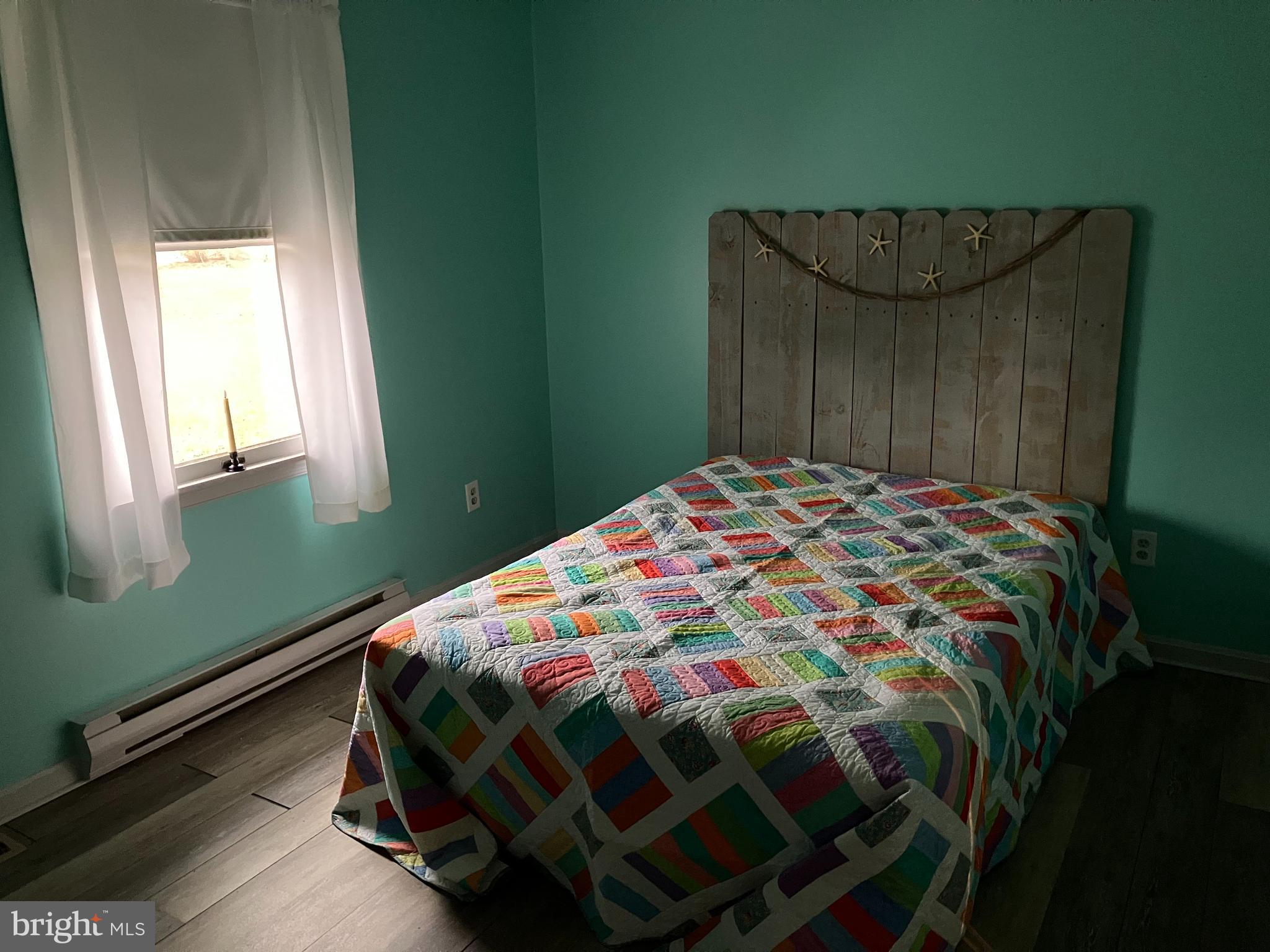 28736 Stockley Road Milton, DE 19968 - Photo 18 of 35 a bedroom with a bed and a window