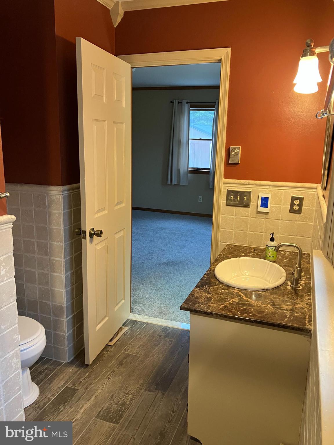 28736 Stockley Road Milton, DE 19968 - Photo 23 of 35 a bathroom with a granite countertop sink and a mirror