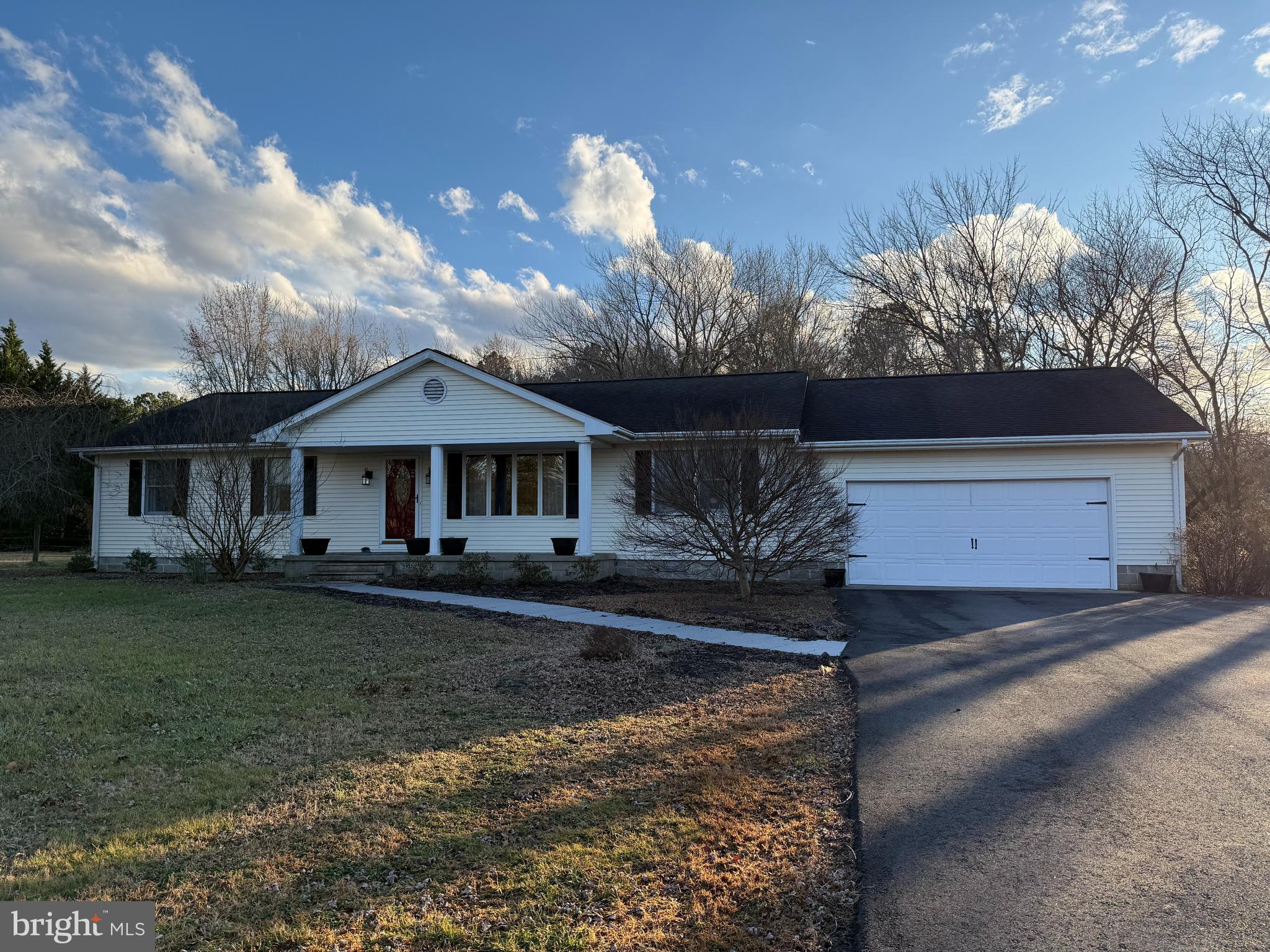 28736 Stockley Road Milton, DE 19968 - Photo 3 of 35 a front view of a house with garden