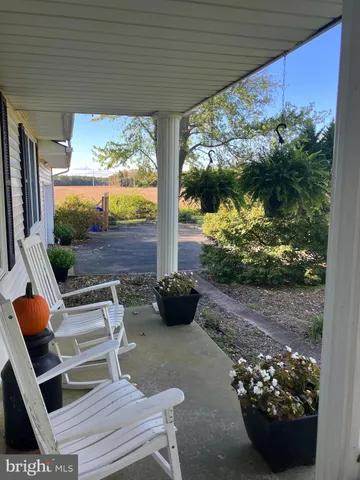 a view of a porch with furniture and garden