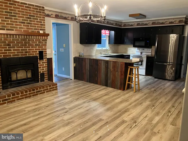 a kitchen with stainless steel appliances granite countertop a refrigerator and a stove top oven