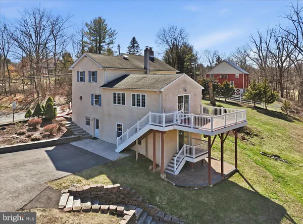 a view of a deck with wooden floor and fence with a bench